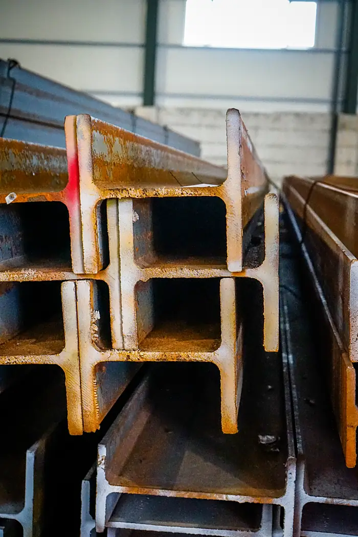 Wide-flange steel beams stacked in the yard