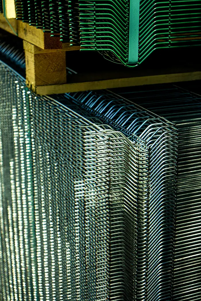 Welded mesh fence panels stacked, green PVC-coated and galvanised